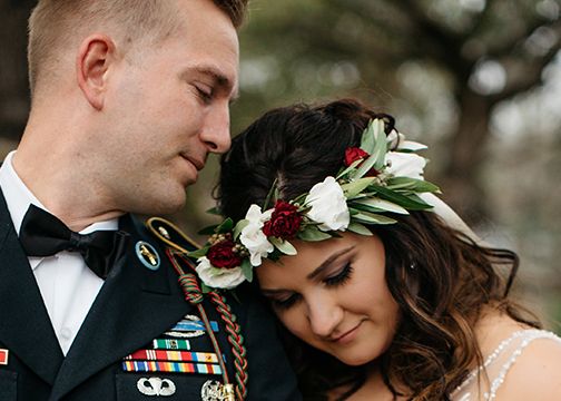 soldier and wife deep red and white floral crown wedding flowers