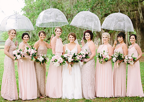 bride and bridesmaids pink and white bouquets and clear umbrellas wedding florals