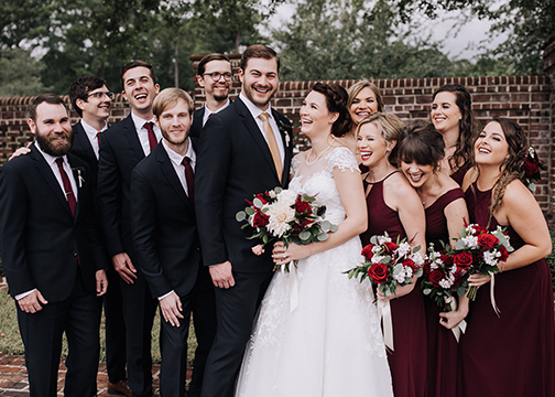 bride and groom and bridal party red garnet and white floral bouquets wedding florist
